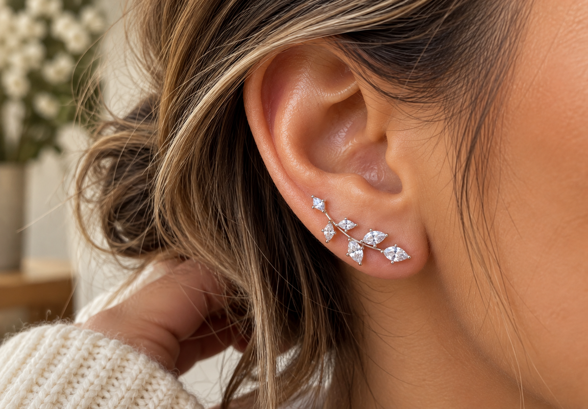 ChalkboardxChaos silver-tone crystal leaf branch earrings worn on a woman's ear with marquise-shaped stones