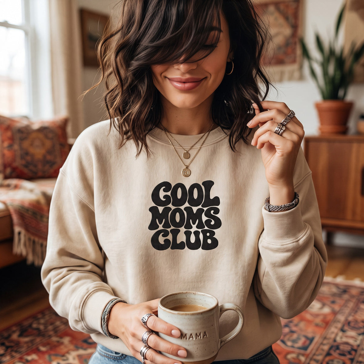 ChalkboardxChaos beige crewneck sweatshirt with black retro bubble lettering reading Cool Moms Club on a woman