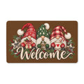 ChalkboardxChaos polyester Christmas doormat featuring three festive gnomes with Welcome text and holiday greenery.