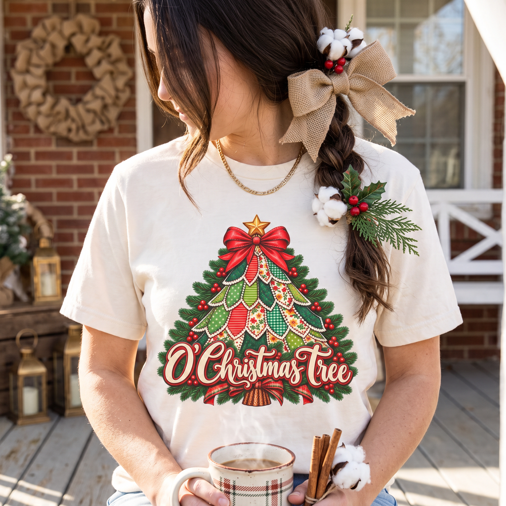 ChalkboardxChaos cream Comfort Colors tee with a vintage patchwork Christmas tree graphic and festive red bow