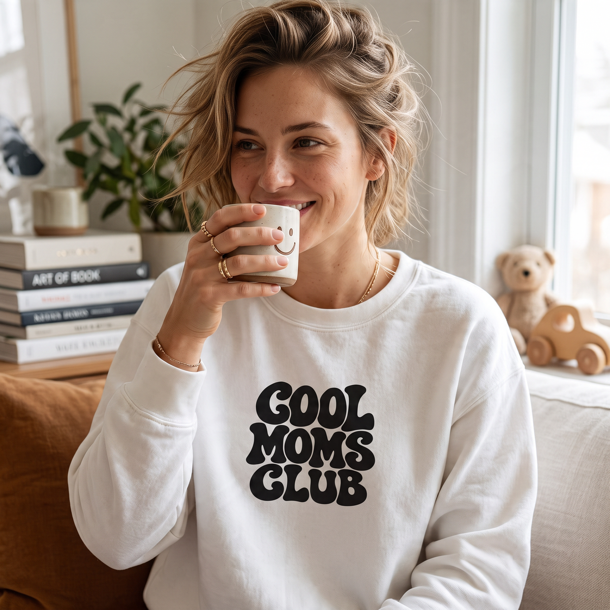 ChalkboardxChaos white crewneck sweatshirt with black retro bubble lettering reading Cool Moms Club on a smiling woman
