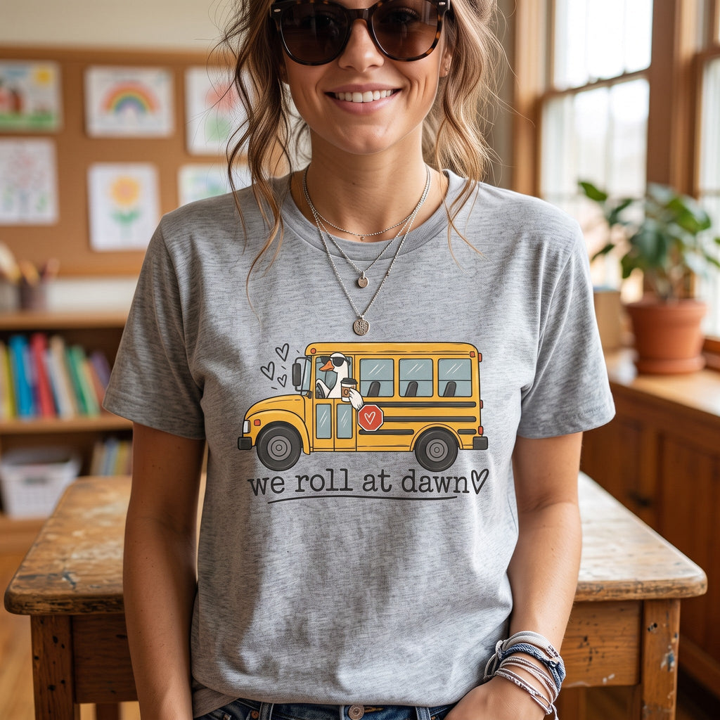 ChalkboardxChaos grey teacher t-shirt featuring a yellow school bus graphic with a coffee-drinking driver and text.