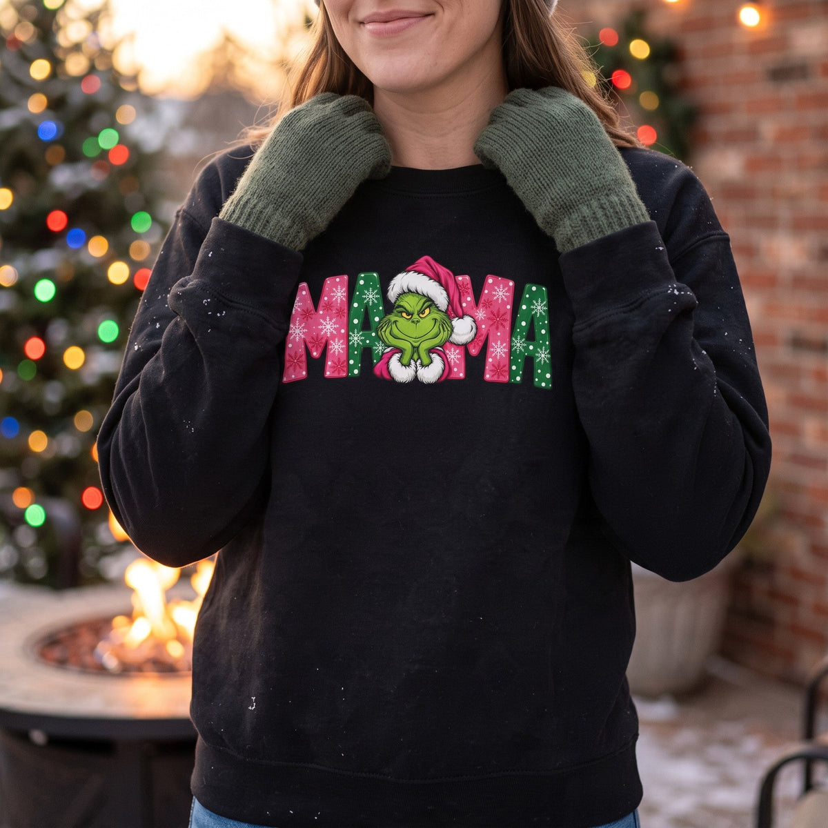 ChalkboardxChaos black sweatshirt with Grinch MAMA graphic in pink and green, worn by a woman with green mittens.