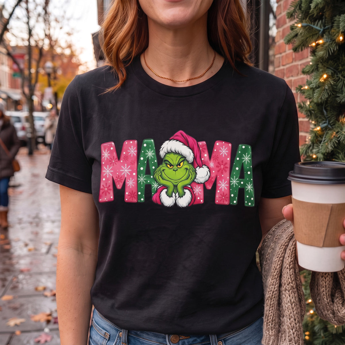 ChalkboardxChaos Grinch Mama Christmas graphic tee in black with pink and green snowflake lettering and Santa hat.