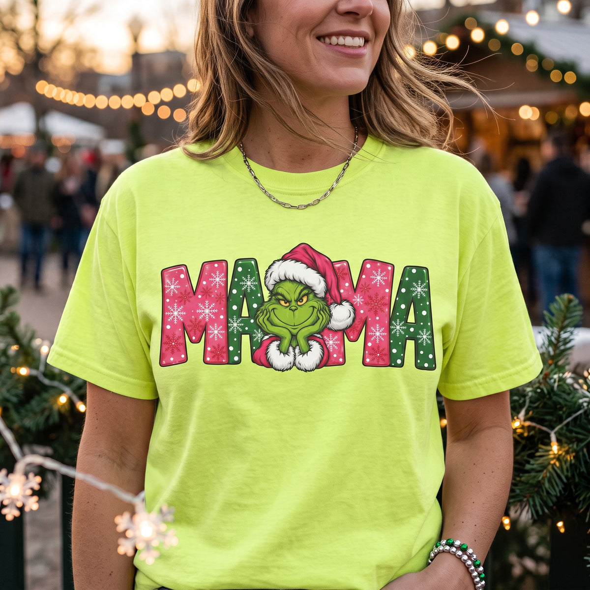 ChalkboardxChaos neon green Grinch Mama Christmas t-shirt with pink and green snowflake lettering and Santa hat.