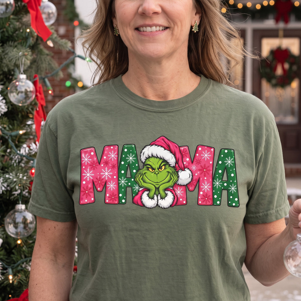 ChalkboardxChaos olive green Grinch Mama Christmas t-shirt with pink and green snowflake lettering and Santa hat design