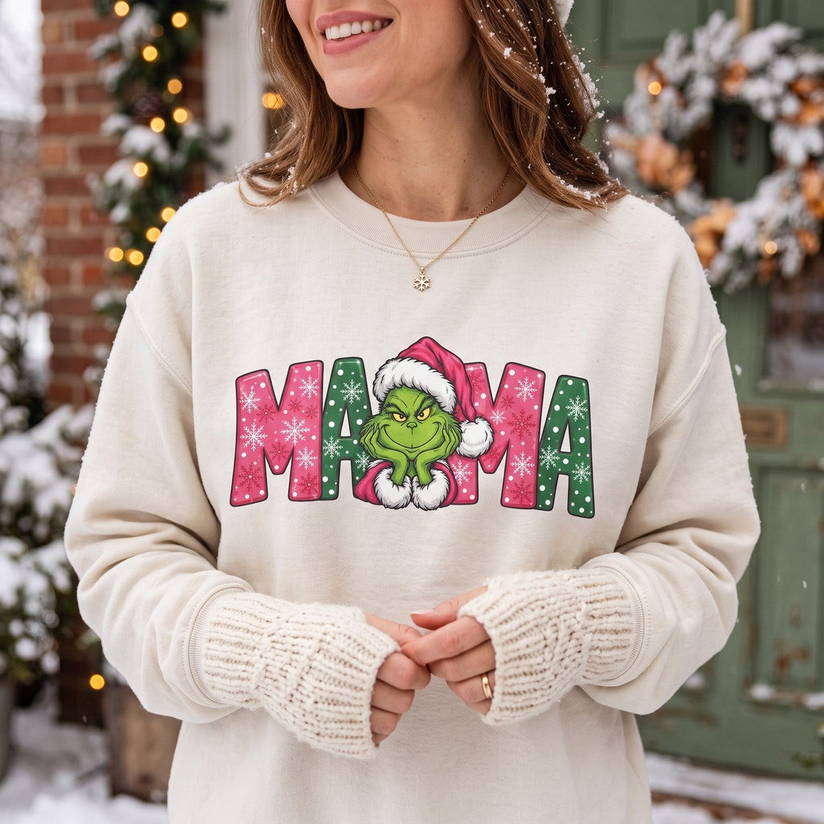 ChalkboardxChaos cream sweatshirt with Grinch MAMA graphic featuring pink and green snowflake lettering and Santa hat.
