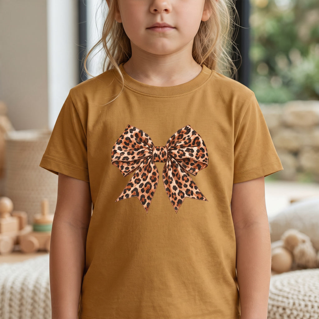ChalkboardxChaos kids t-shirt in mustard yellow featuring a large leopard print bow graphic on the front