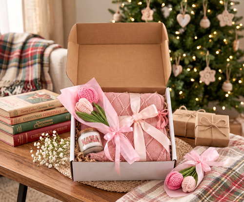 ChalkboardxChaos Christmas gift set featuring a pink knit blanket, Mama candle, and handmade crochet flowers in a box