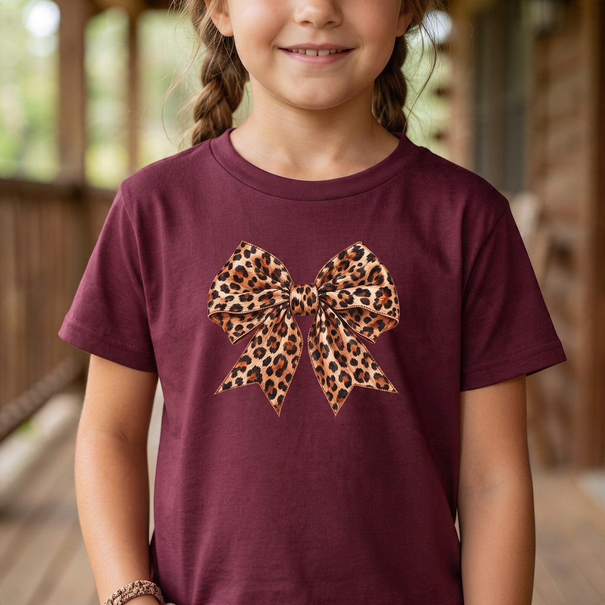 ChalkboardxChaos kids maroon t-shirt featuring a large leopard print bow graphic on the front