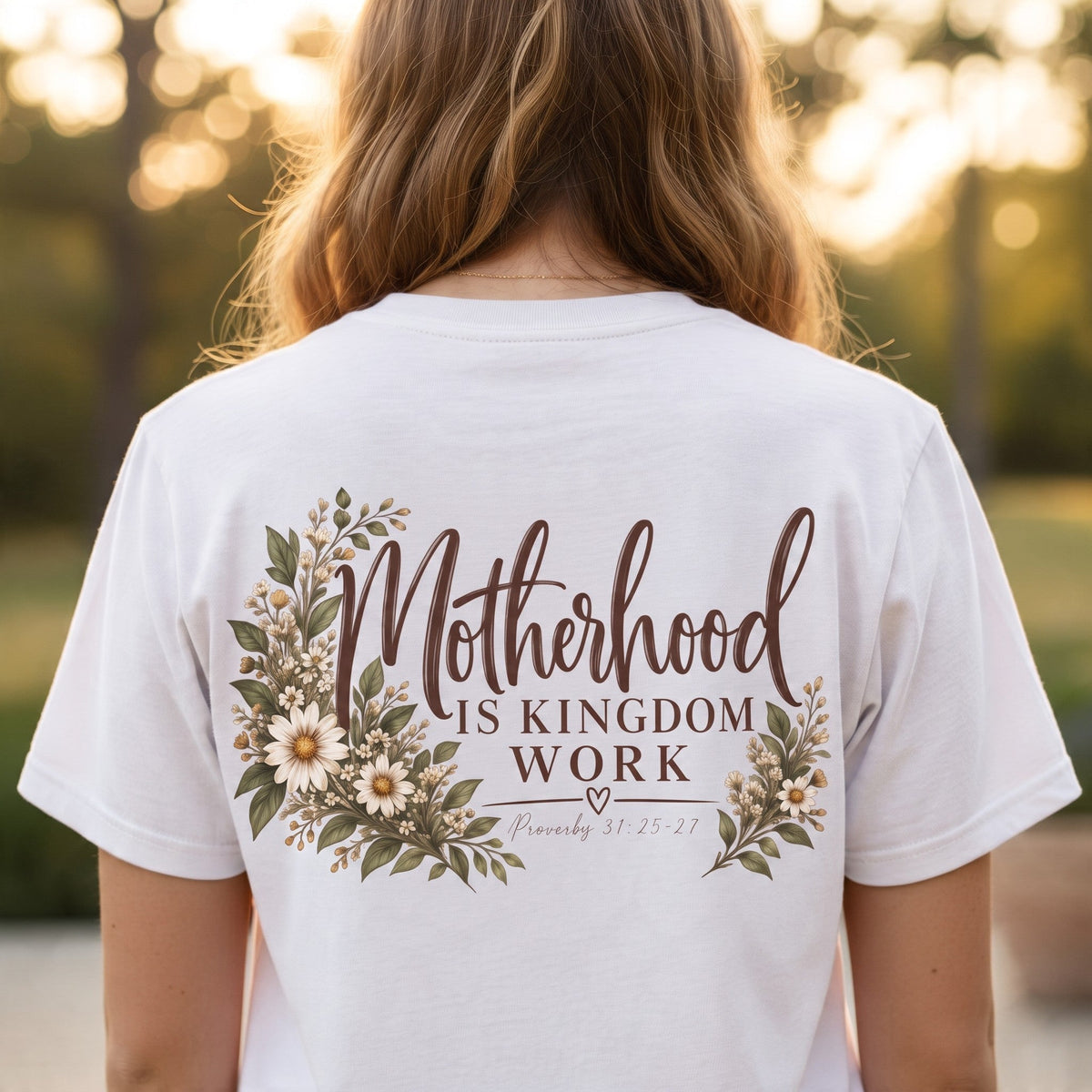 ChalkboardxChaos white graphic tee with Motherhood Is Kingdom Work text and floral botanical design on the back