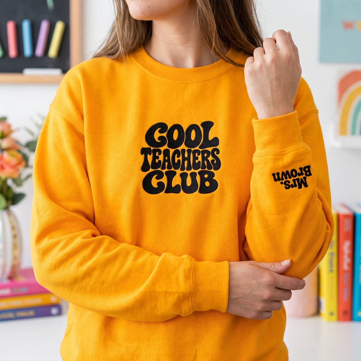 ChalkboardxChaos yellow sweatshirt with Cool Teachers Club retro bubble text and personalized name on the wrist