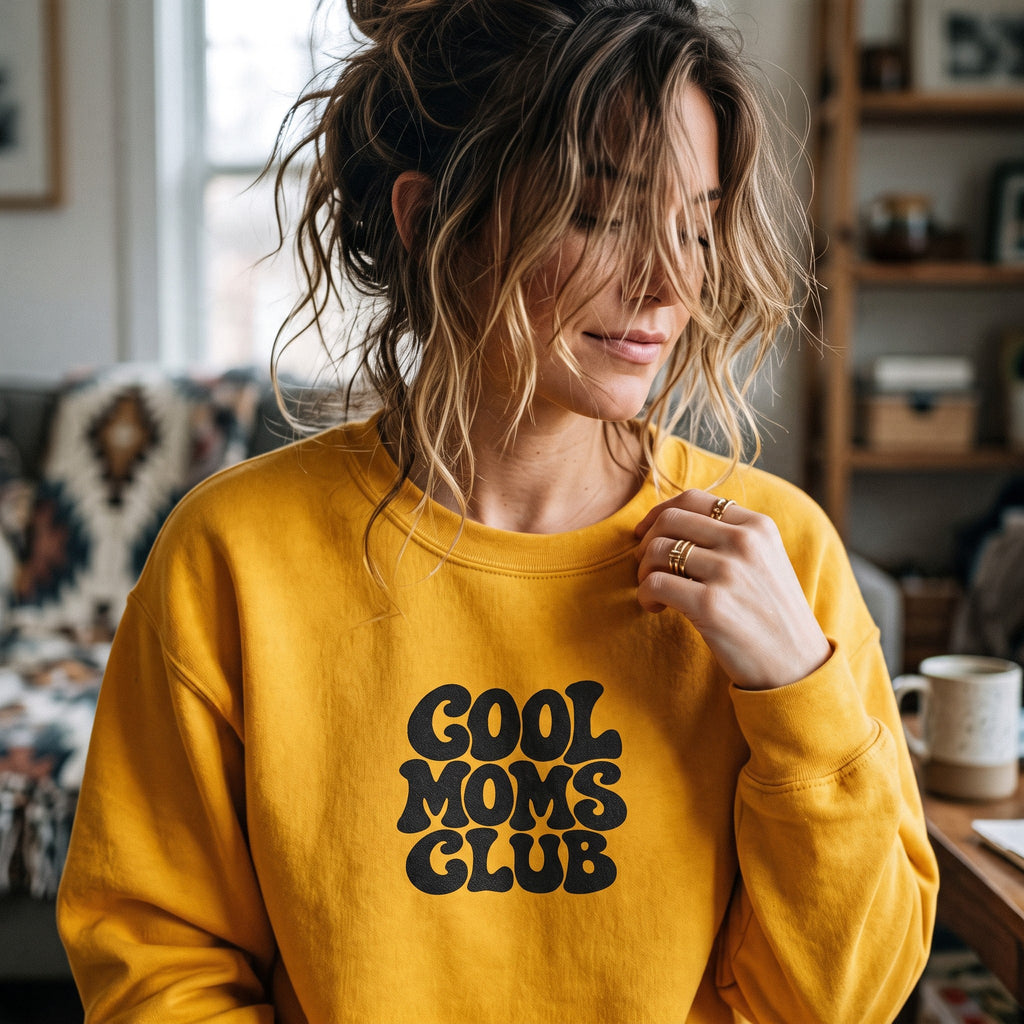 ChalkboardxChaos mustard yellow crewneck sweatshirt featuring black retro bubble lettering that says Cool Moms Club.