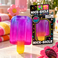 ChalkboardxChaos NeeDoh Nice-Sicle squishy toy in purple, pink, and orange with a yellow stick next to its packaging.