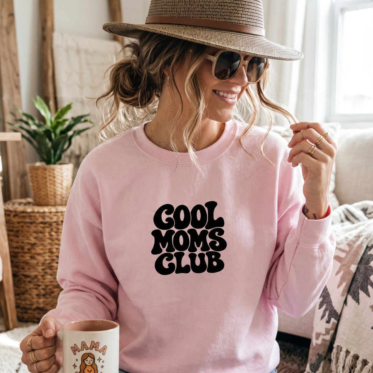 ChalkboardxChaos light pink crewneck sweatshirt with black retro bubble lettering reading Cool Moms Club on a woman
