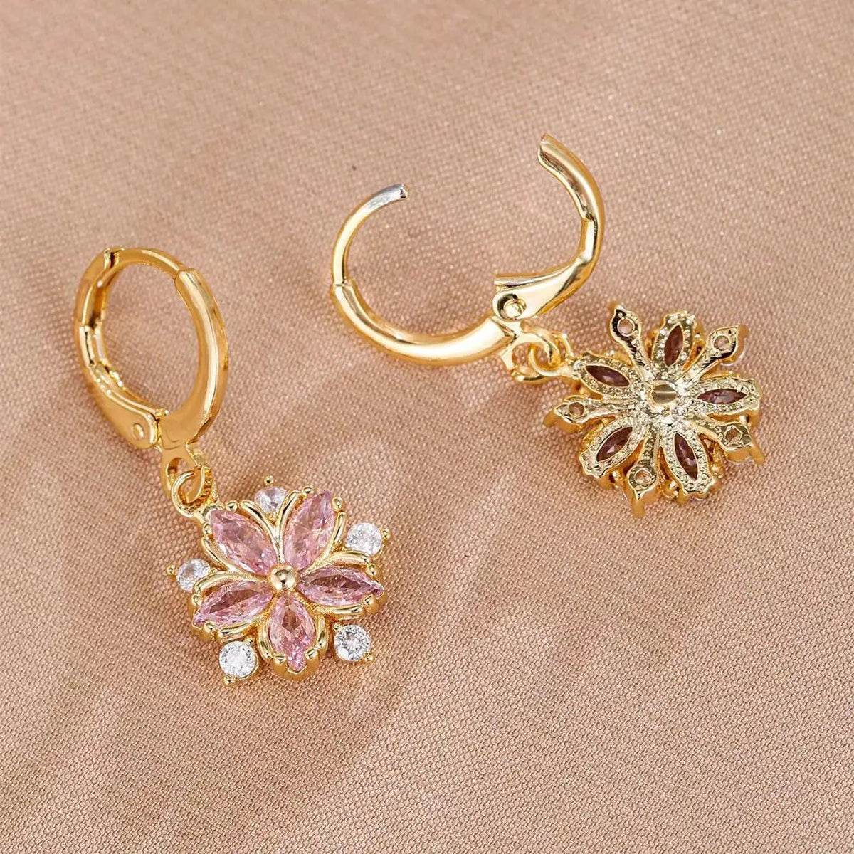 ChalkboardxChaos gold alloy hoop earrings featuring pink marquise-cut crystal flower pendants with clear stone accents.