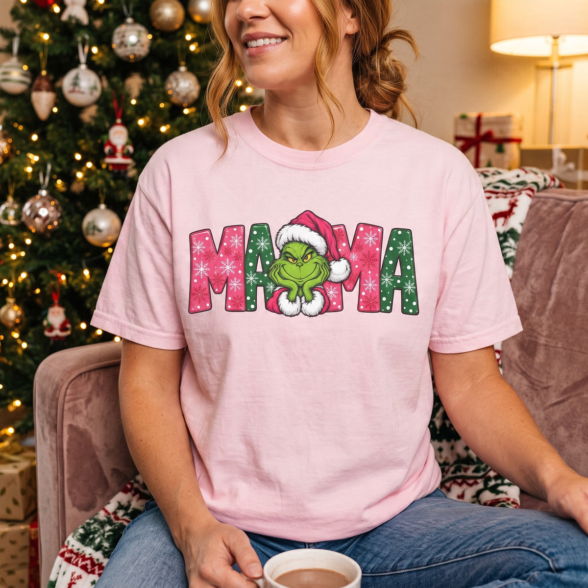 ChalkboardxChaos pink Grinch Mama Christmas t-shirt with green and pink snowflake lettering and a Santa hat graphic.