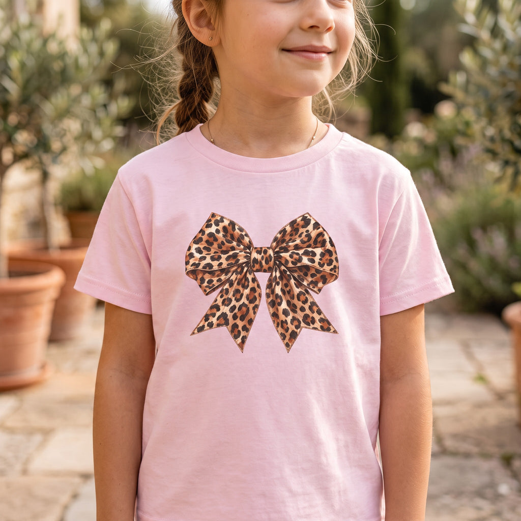 ChalkboardxChaos light pink t-shirt for girls featuring a large leopard print bow graphic in tan and black tones.