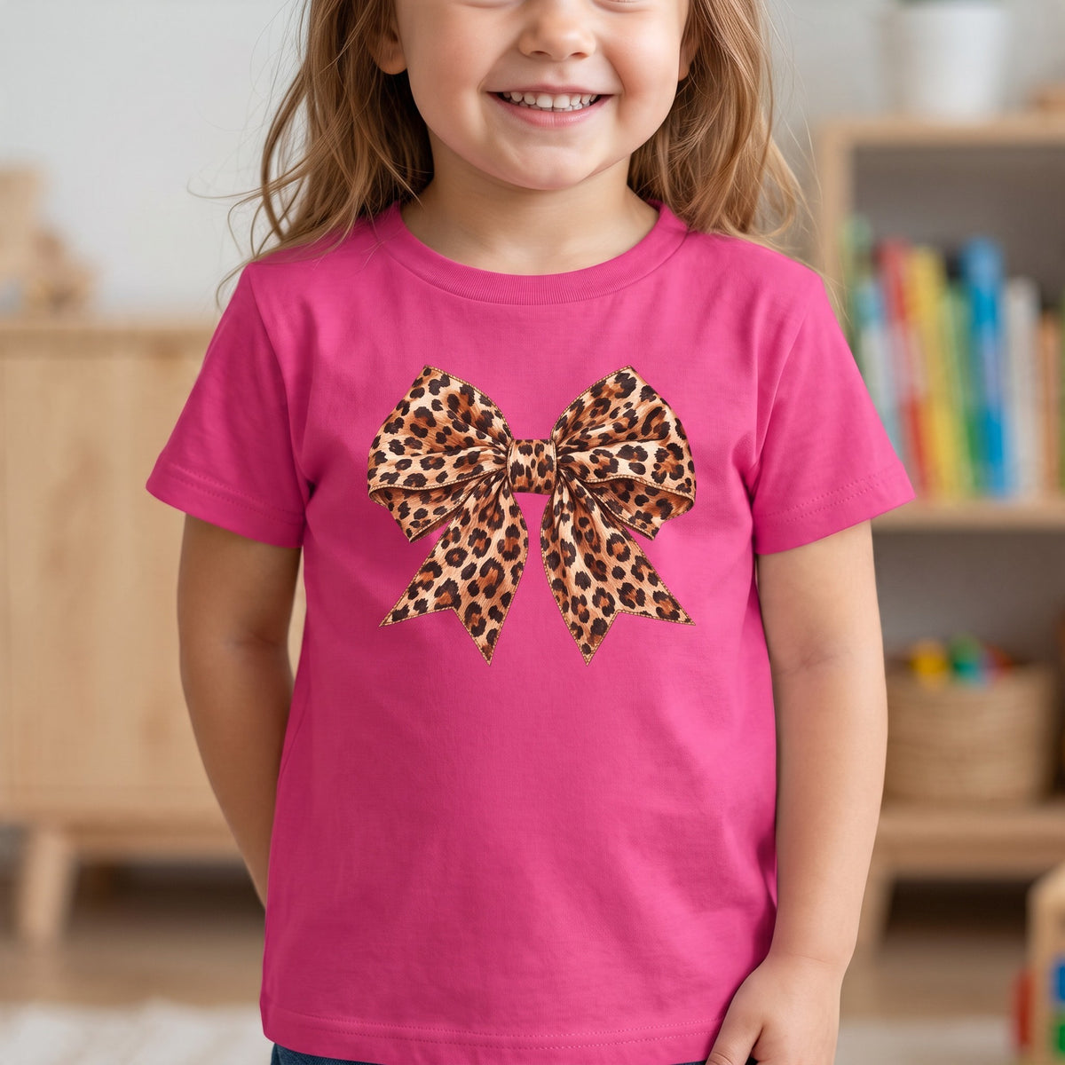 ChalkboardxChaos pink short-sleeve t-shirt for girls featuring a large leopard print bow graphic on the front