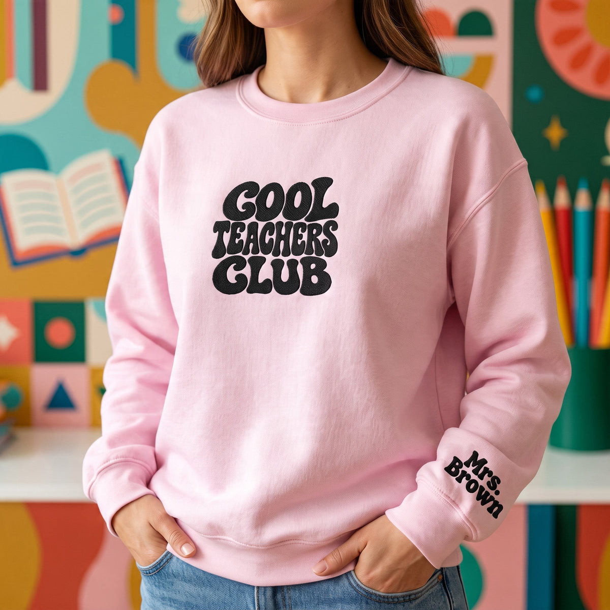 ChalkboardxChaos light pink sweatshirt with Cool Teachers Club retro bubble text and personalized wrist embroidery.