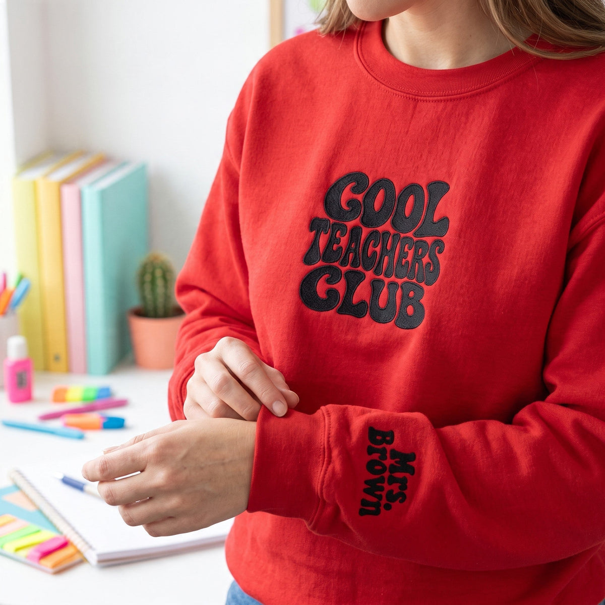 ChalkboardxChaos red sweatshirt with Cool Teachers Club embroidery and personalized name on the wrist