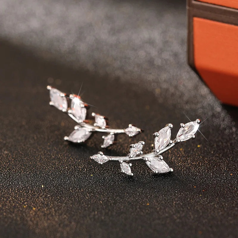 ChalkboardxChaos silver-tone crystal leaf branch earrings with marquise-cut stones on a dark textured surface