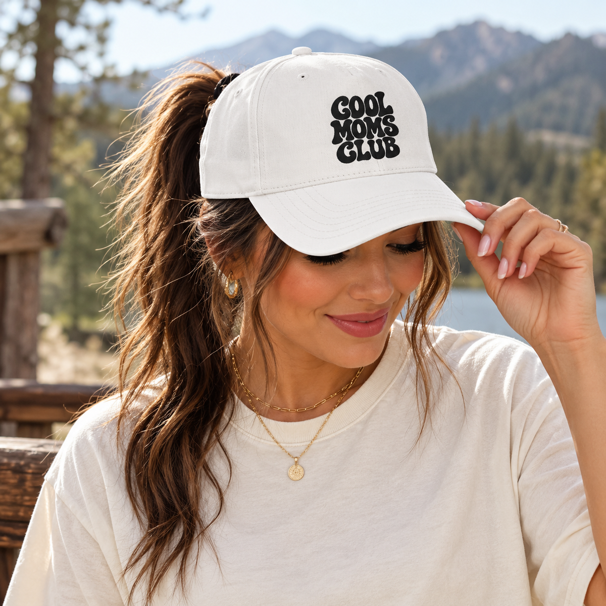 ChalkboardxChaos white baseball cap with Cool Moms Club embroidery worn by a woman outdoors.
