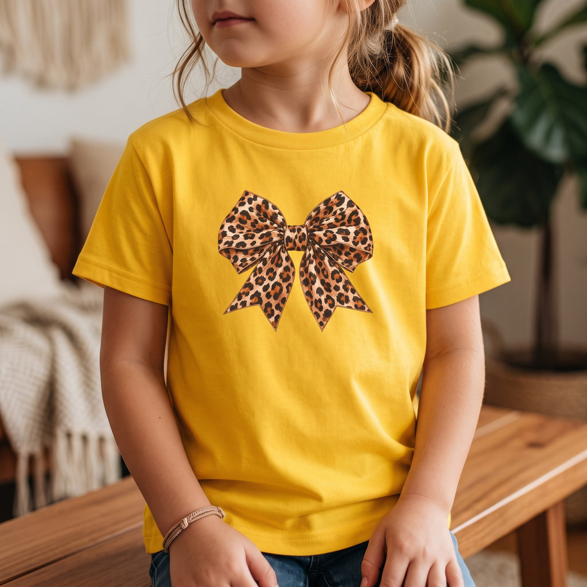 ChalkboardxChaos yellow kids t-shirt featuring a realistic leopard print bow graphic for a trendy boutique look.